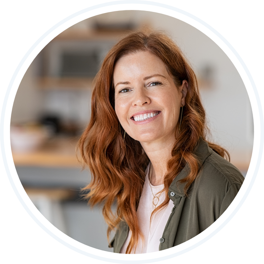 Smiling woman with red hair and a green shirt - Sweet Sheets Review