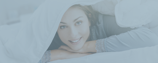 Woman lying on a bed of Sweet Sheets® with a blurred background